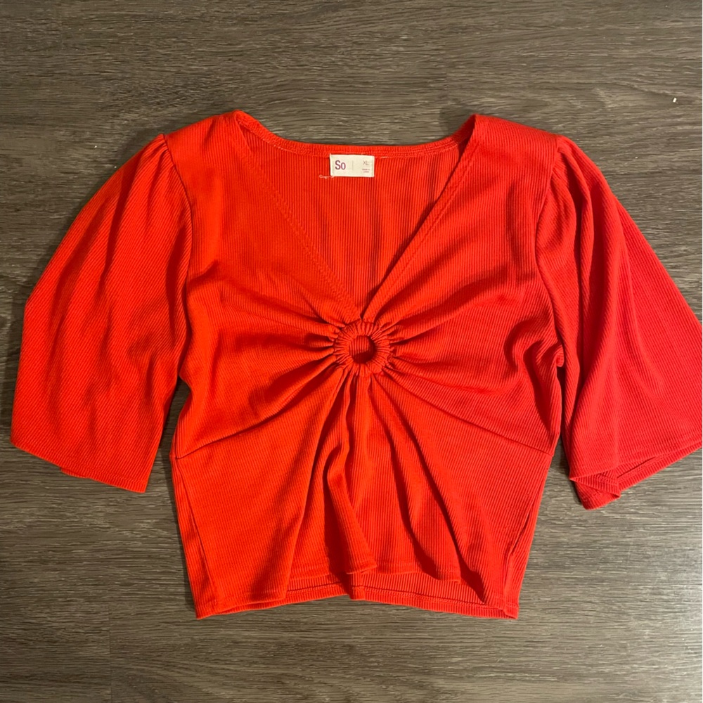 Red crop top with circlet detail. V neck. Lightly worn.